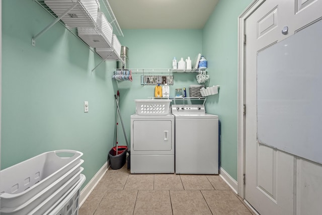 washroom with separate washer and dryer and light tile patterned flooring