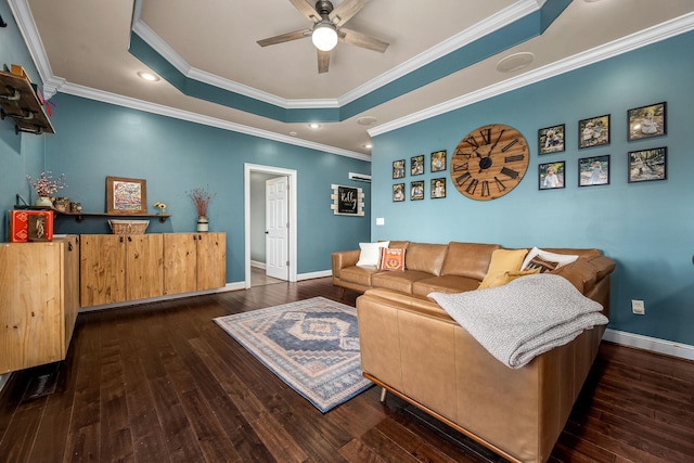 living room with a raised ceiling, ceiling fan, ornamental molding, and dark hardwood / wood-style flooring