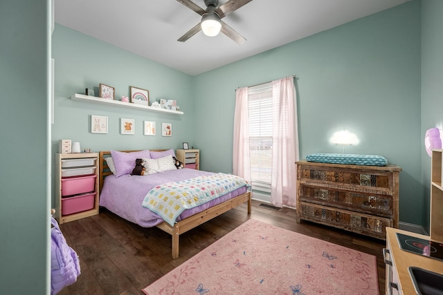 bedroom with dark wood-type flooring and ceiling fan