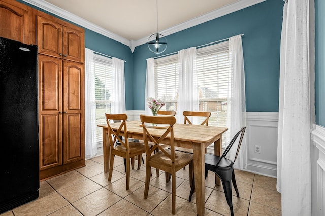 dining space featuring ornamental molding and light tile patterned flooring