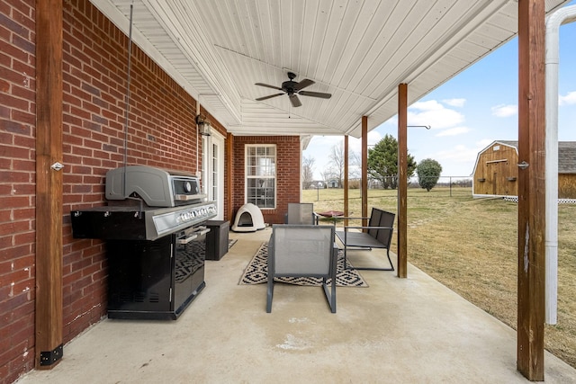 view of patio / terrace featuring ceiling fan and a storage unit