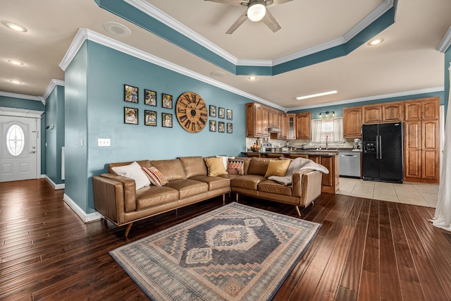 living room with crown molding, dark wood-type flooring, and a healthy amount of sunlight