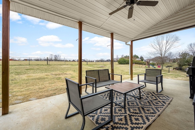 view of patio with ceiling fan, an outdoor hangout area, a playground, and a rural view