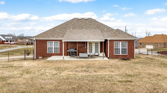 back of property featuring a patio and a lawn