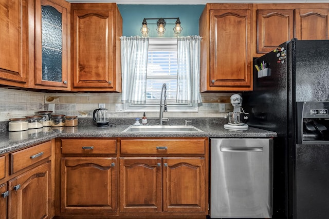 kitchen with dishwasher, black fridge, sink, and decorative backsplash