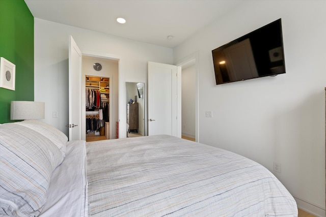 bedroom featuring a spacious closet and a closet