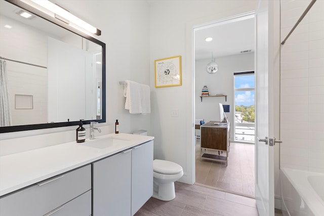 full bathroom featuring vanity, toilet, and  shower combination