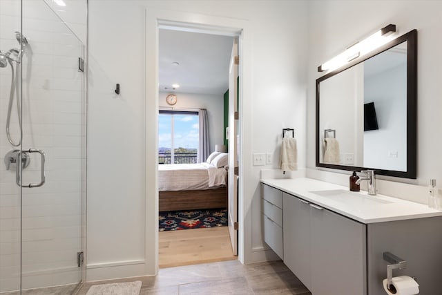 bathroom with walk in shower, vanity, and wood-type flooring