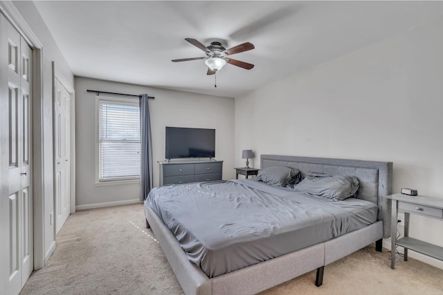 bedroom with light colored carpet and ceiling fan