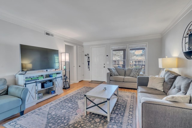 living room featuring ornamental molding and wood-type flooring