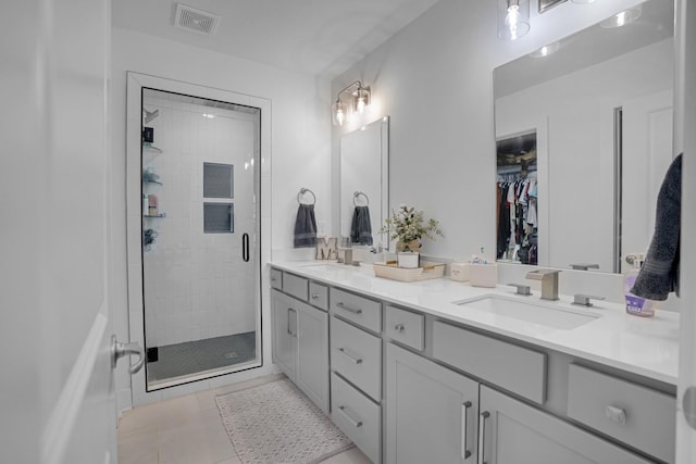 bathroom with tile patterned flooring, vanity, and an enclosed shower