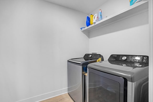 washroom featuring wood-type flooring and washer and dryer