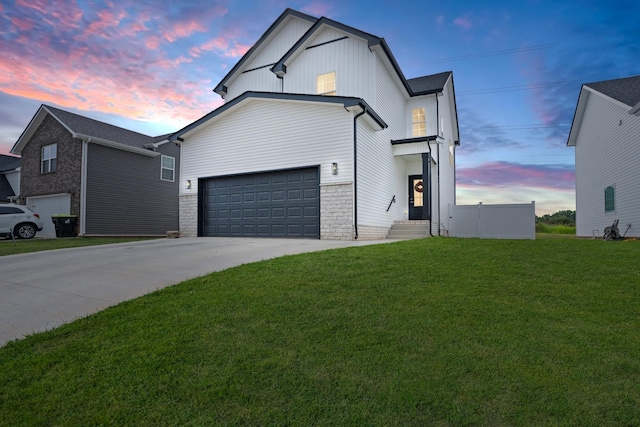 modern inspired farmhouse with a garage and a lawn