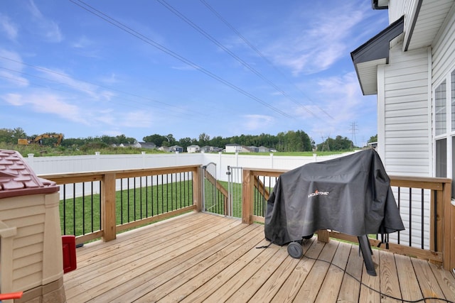 wooden deck with a grill and a lawn