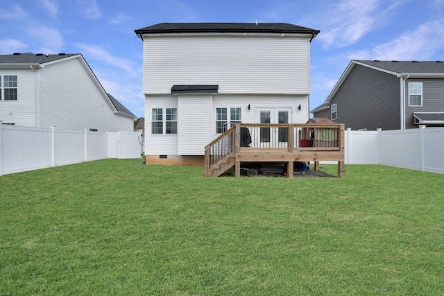 rear view of house with a yard and a deck