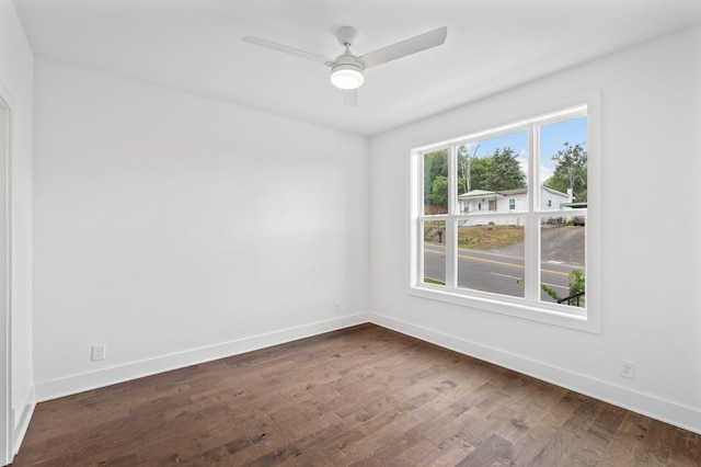 spare room with ceiling fan and dark hardwood / wood-style flooring