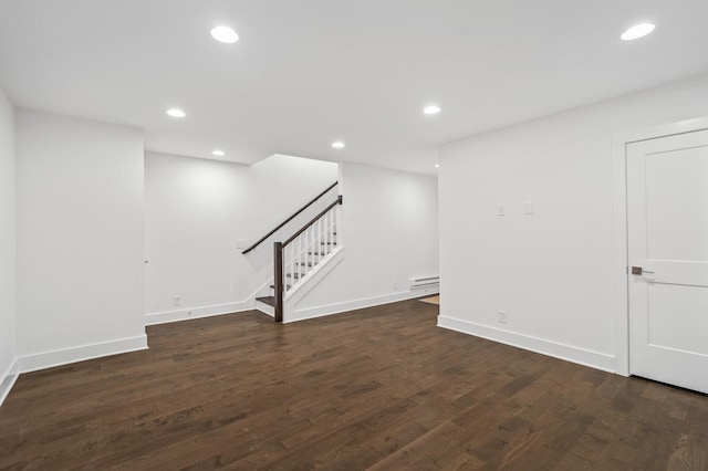 interior space with dark wood-type flooring and baseboard heating