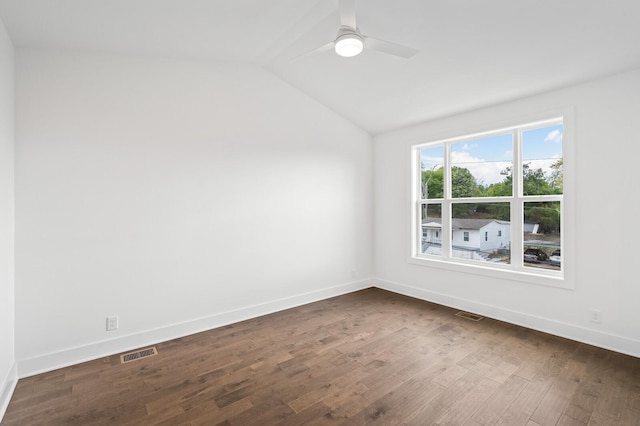 empty room with dark wood-type flooring, ceiling fan, and vaulted ceiling