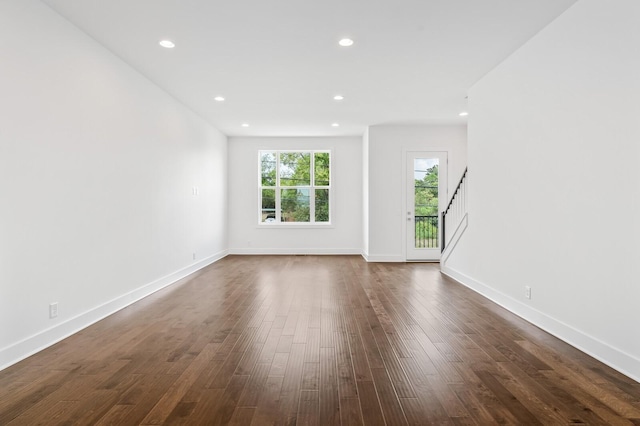 unfurnished living room featuring dark hardwood / wood-style flooring