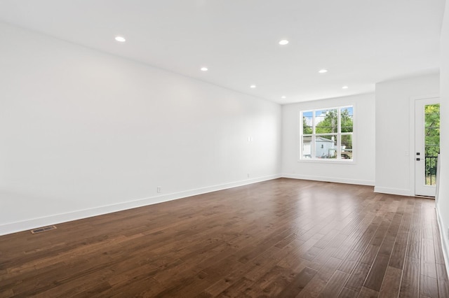 unfurnished room with dark hardwood / wood-style floors