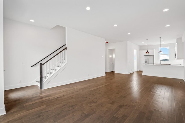 unfurnished living room featuring dark hardwood / wood-style flooring