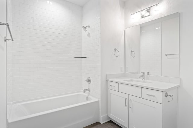 bathroom with tiled shower / bath combo and vanity