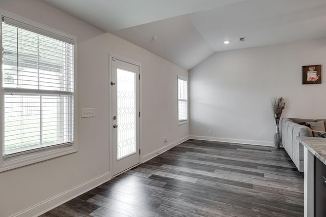 foyer entrance with lofted ceiling and dark hardwood / wood-style floors