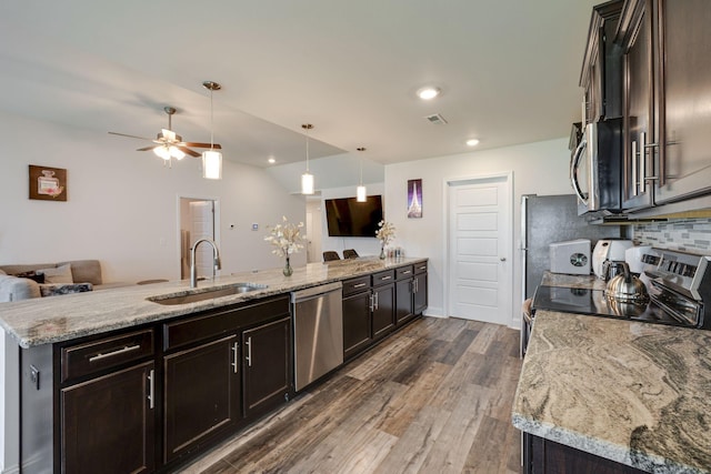 kitchen with dark brown cabinetry, sink, appliances with stainless steel finishes, dark hardwood / wood-style floors, and pendant lighting