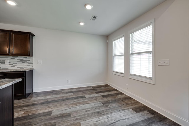 unfurnished dining area with dark hardwood / wood-style floors