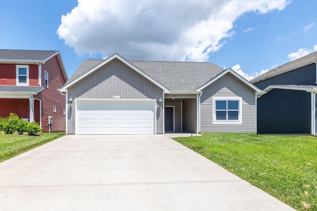 view of front of home with a garage and a front lawn