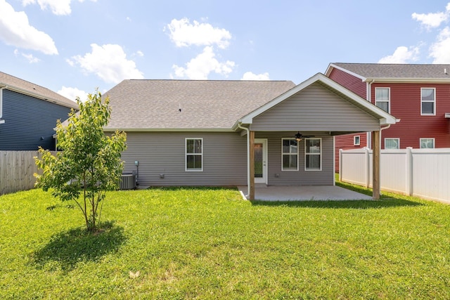 rear view of property with a yard, cooling unit, ceiling fan, and a patio area