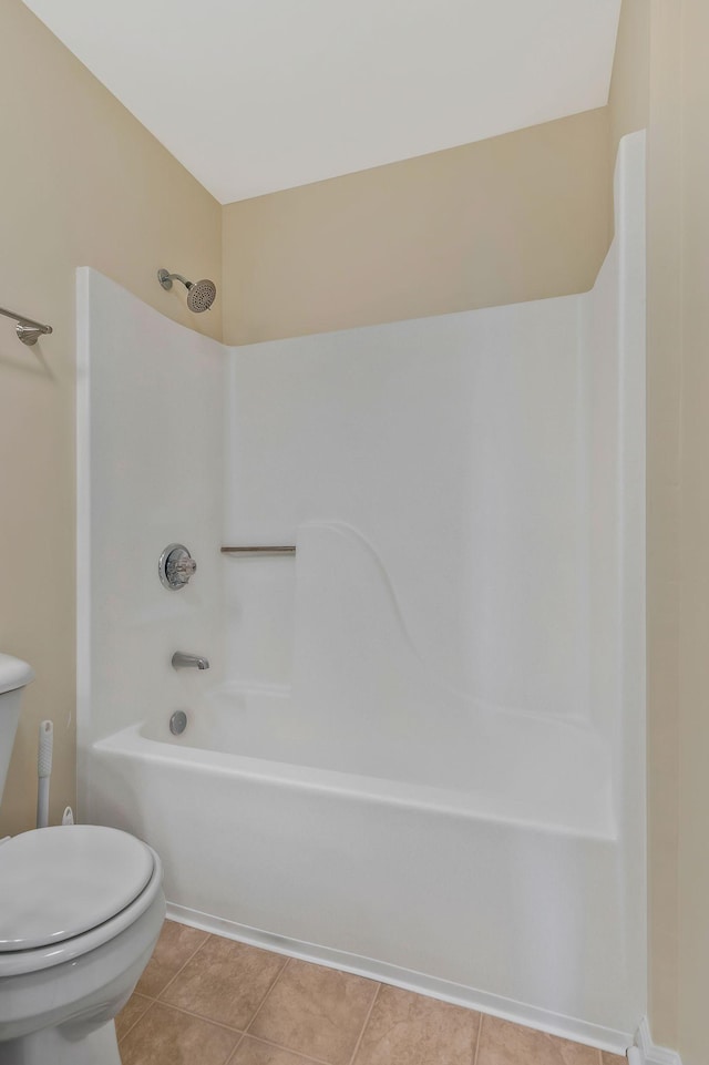 bathroom with tub / shower combination, tile patterned floors, and toilet