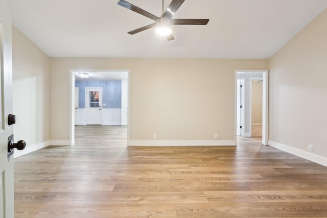 empty room with ceiling fan and light wood-type flooring