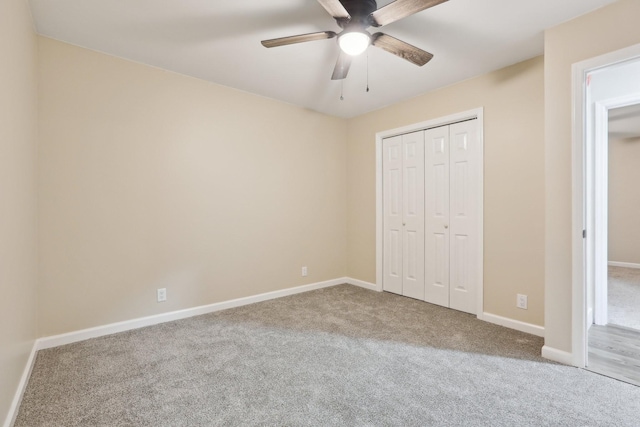 unfurnished bedroom featuring carpet flooring, ceiling fan, and a closet