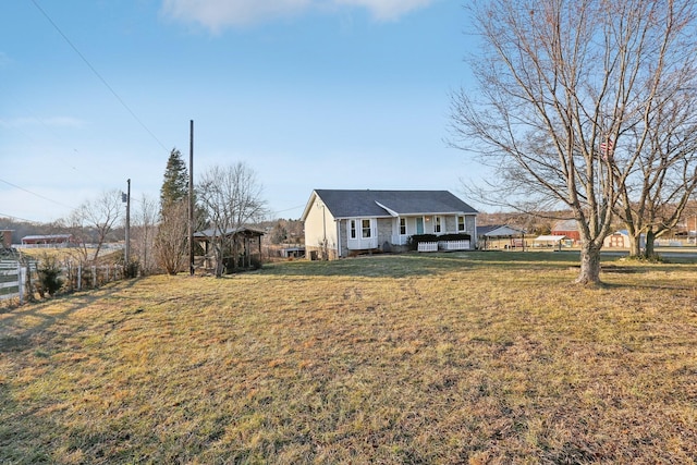 view of front of house with a deck and a front lawn