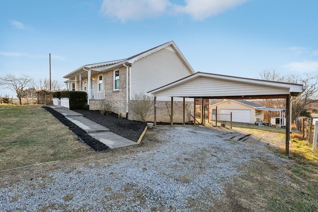 view of side of property featuring a garage, an outdoor structure, and a lawn