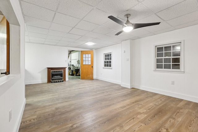 unfurnished living room with wine cooler, hardwood / wood-style flooring, a paneled ceiling, and ceiling fan