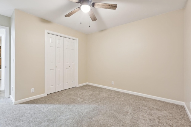 unfurnished bedroom with carpet floors, ceiling fan, and a closet