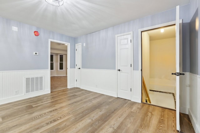 unfurnished room with light hardwood / wood-style floors