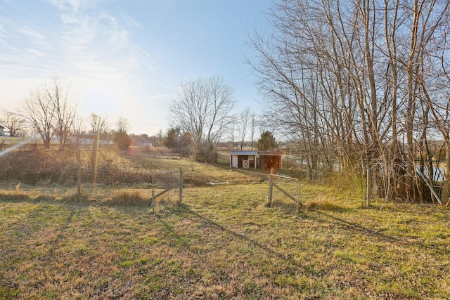 view of yard with a rural view and an outdoor structure