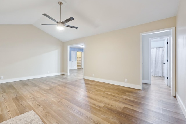 unfurnished room featuring vaulted ceiling, ceiling fan, and light wood-type flooring