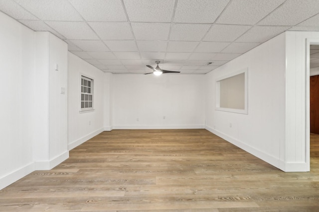 unfurnished room featuring ceiling fan, wood-type flooring, and a drop ceiling