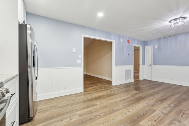 spare room with light wood-type flooring