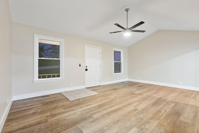 interior space featuring ceiling fan, lofted ceiling, and light hardwood / wood-style floors