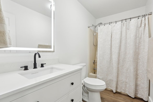 full bathroom featuring vanity, toilet, hardwood / wood-style floors, and shower / bath combo with shower curtain