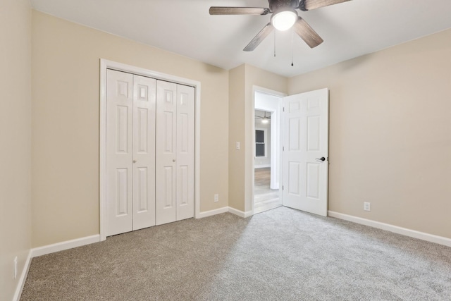 unfurnished bedroom with light colored carpet, a closet, and ceiling fan