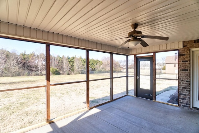 unfurnished sunroom featuring plenty of natural light and ceiling fan