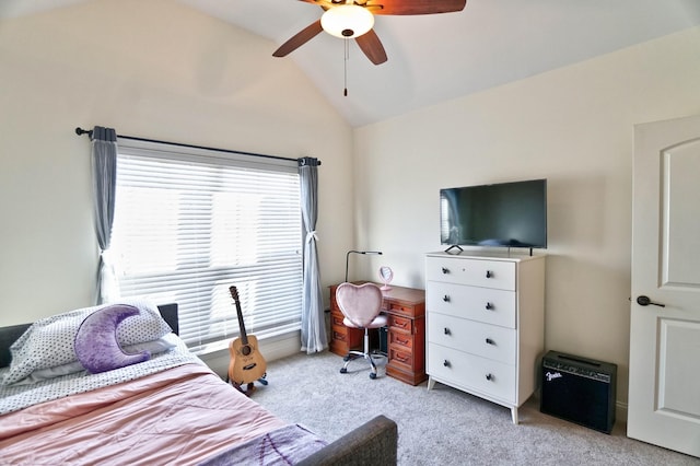 bedroom with vaulted ceiling, light colored carpet, and ceiling fan