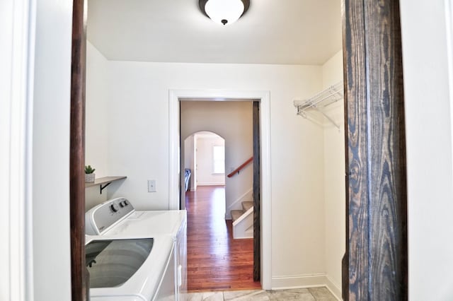 laundry room with light wood-type flooring and independent washer and dryer