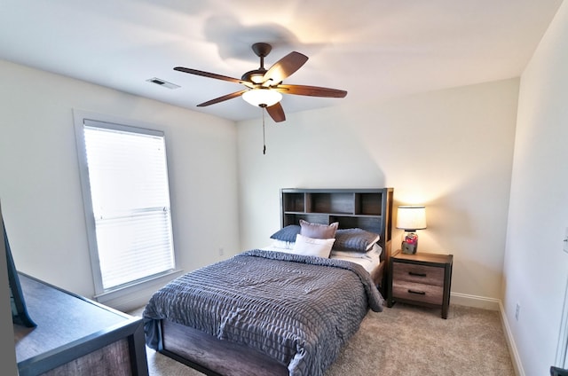 bedroom featuring ceiling fan and light carpet